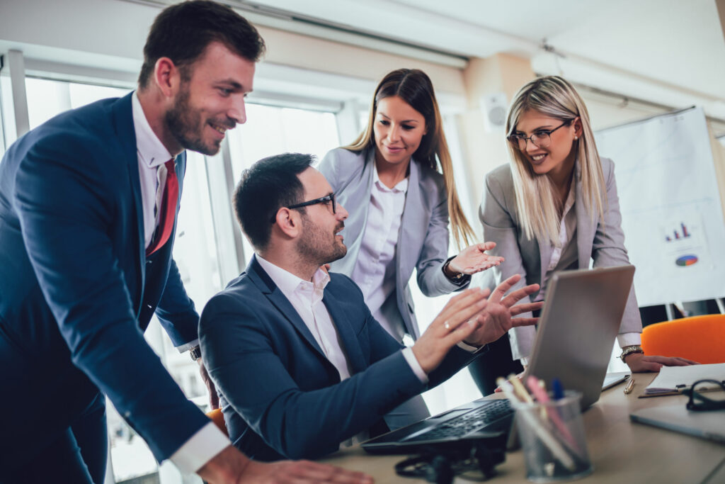 A sales leader showing his team some spreadsheets