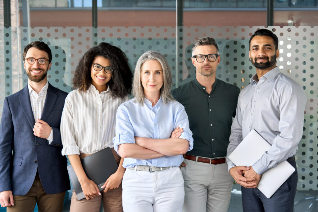 A team of sales recruiters standing confidently.